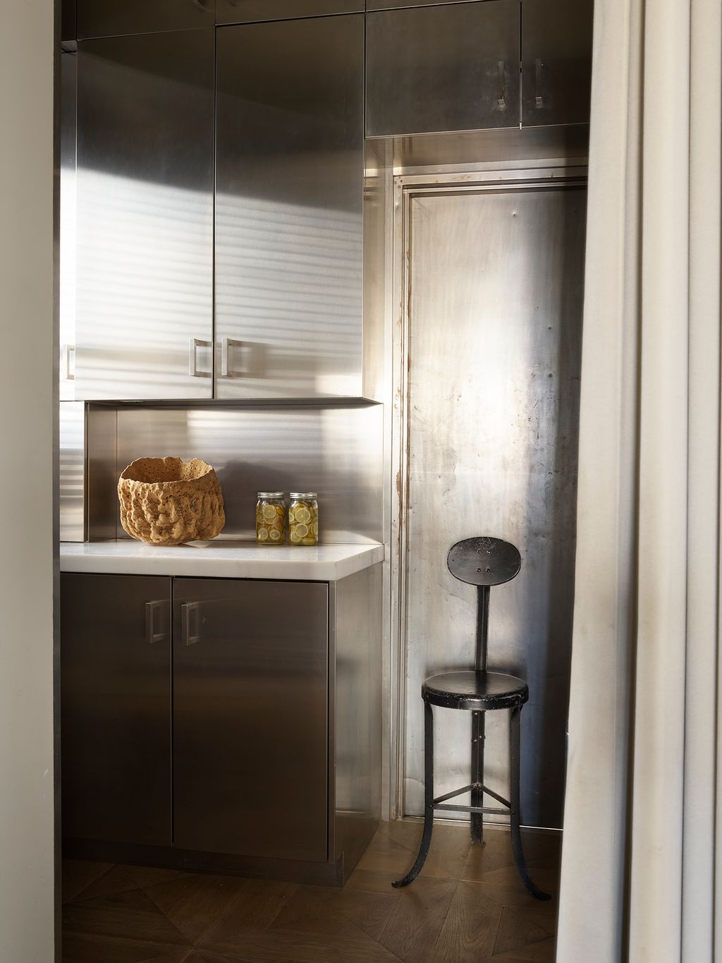 Stephan's restrained approach extends to the kitchen where he used matte stainless steel cabinets. ‘I like a kitchen to...