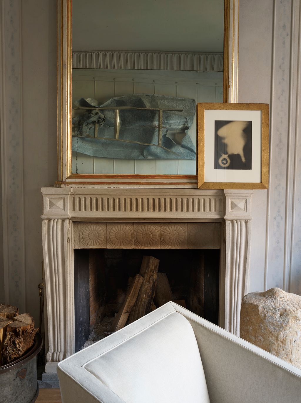 Over the mantlepiece a Man Ray photograph is hung in front of the mirror.