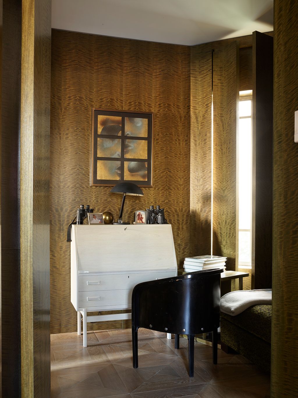 In the dressing room a Hellenistic sculpture on a Danish modern secretaire desk and a painting by Harold Stevenson stand...
