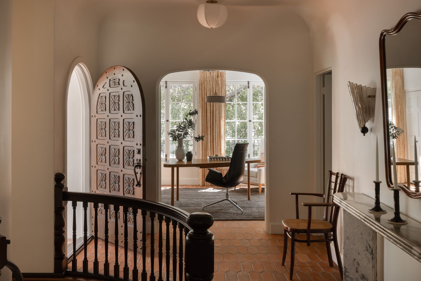 Image may contain Chair Furniture Architecture Building Foyer Indoors Lamp Plant Desk Table Living Room and Room