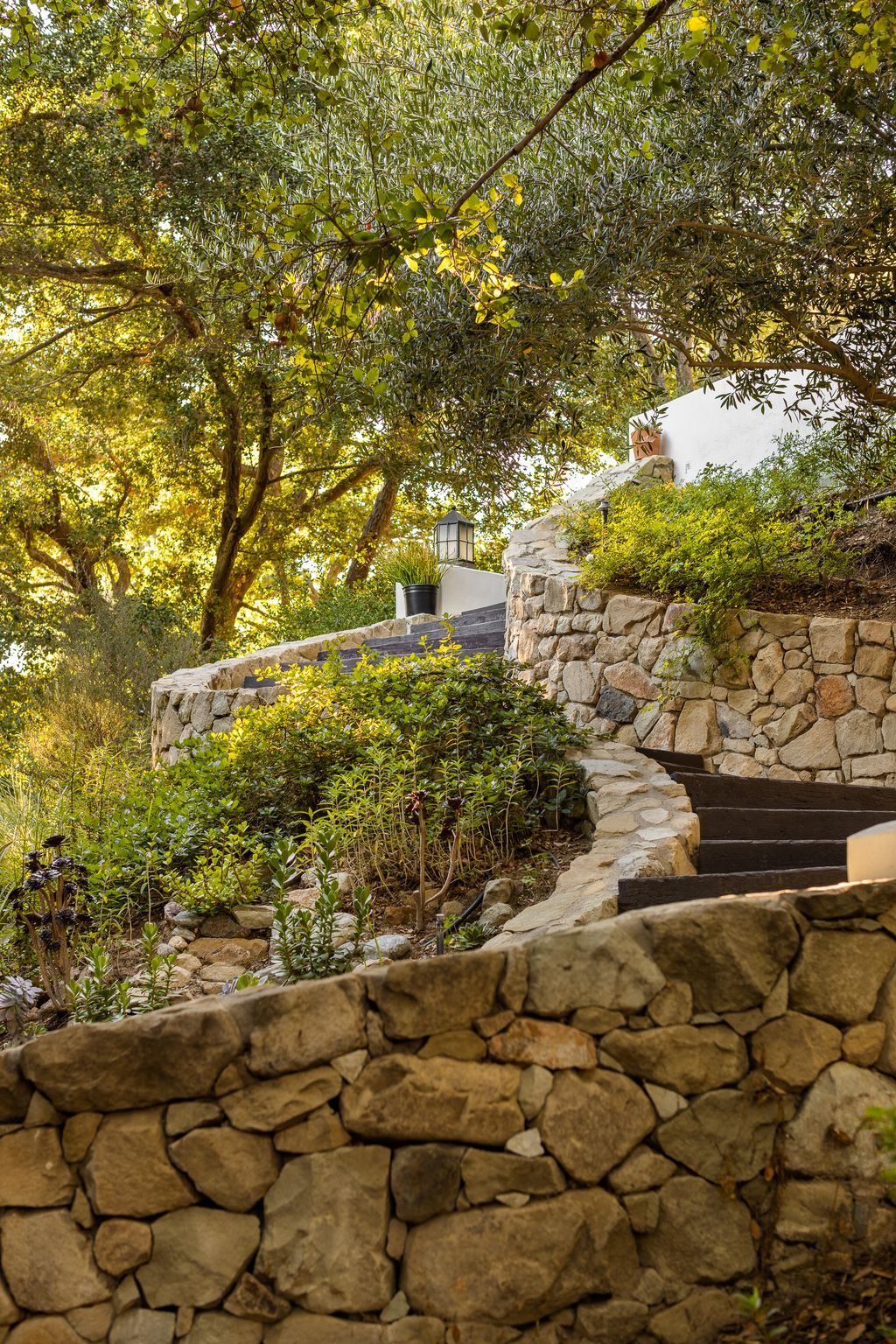 Image may contain Architecture Building Wall Path Walkway Flagstone Rubble Rock Plant Tree Slate and Stone Wall