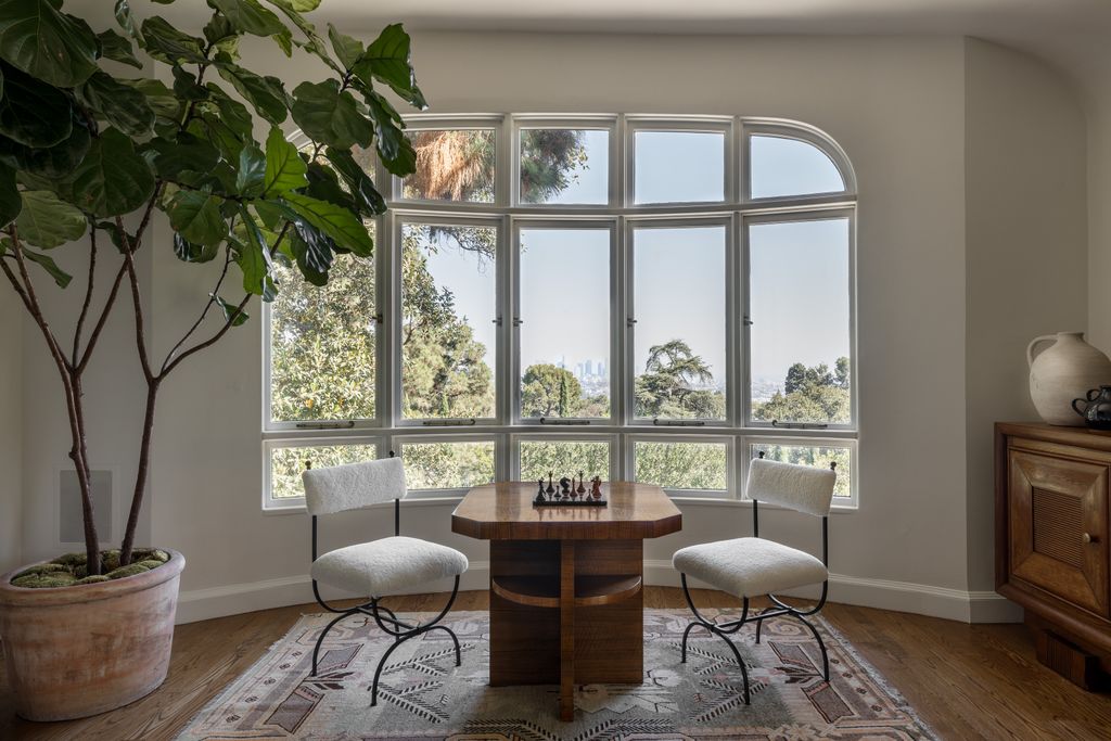 Image may contain Plant Window Chair Furniture Home Decor Rug French Window Desk Table and Bay Window