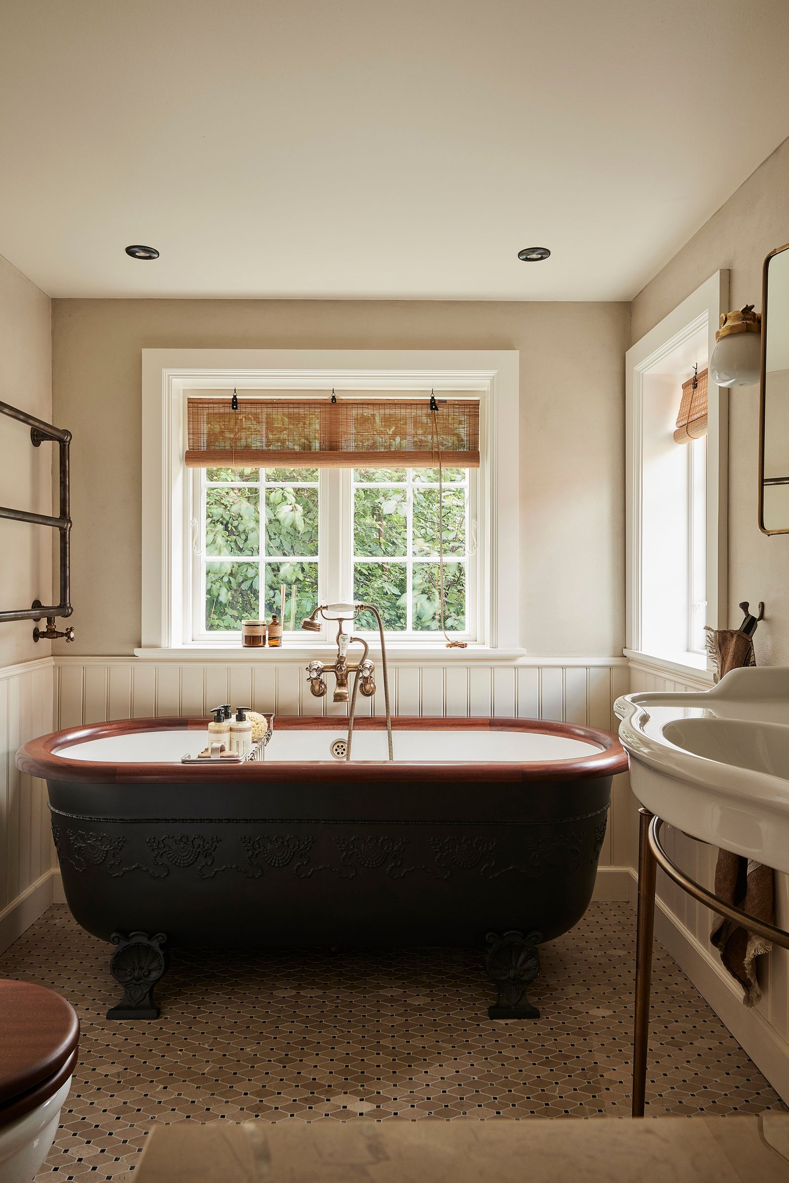 Image may contain Bathing Tub Bathtub Person Sink Indoors Interior Design and Sink Faucet