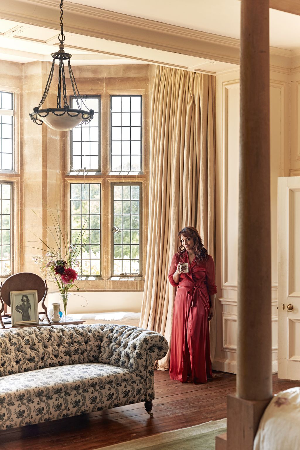 Image may contain Danielle de Niese Lamp Couch Furniture Adult Person Window Art Painting Chair and Indoors