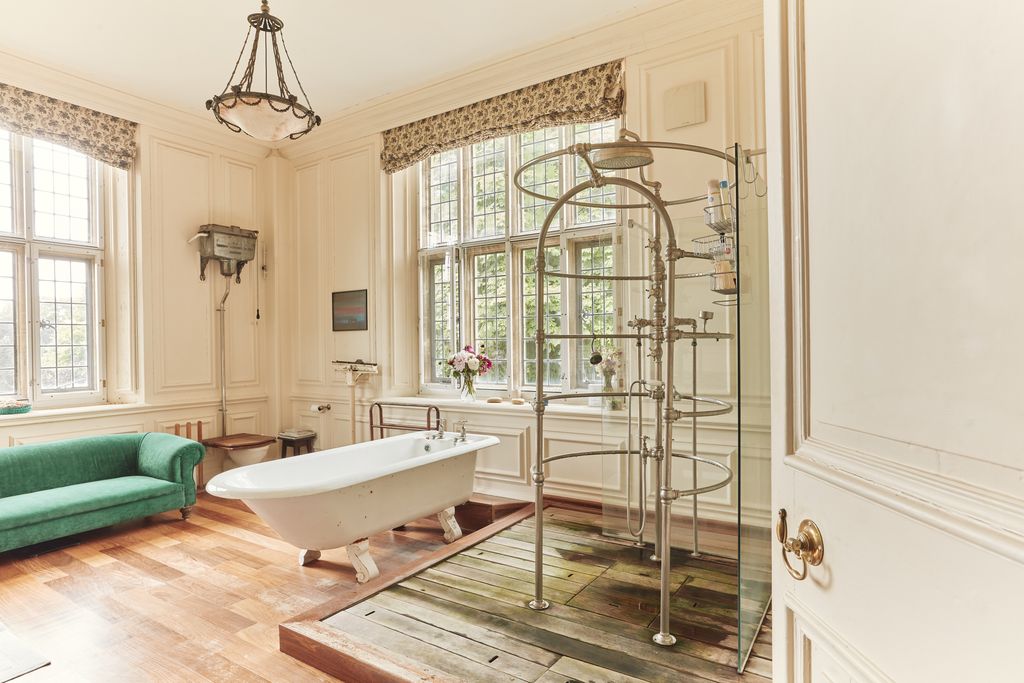 Image may contain Bathing Bathtub Person Tub Indoors Interior Design Couch Furniture Lamp and Chandelier