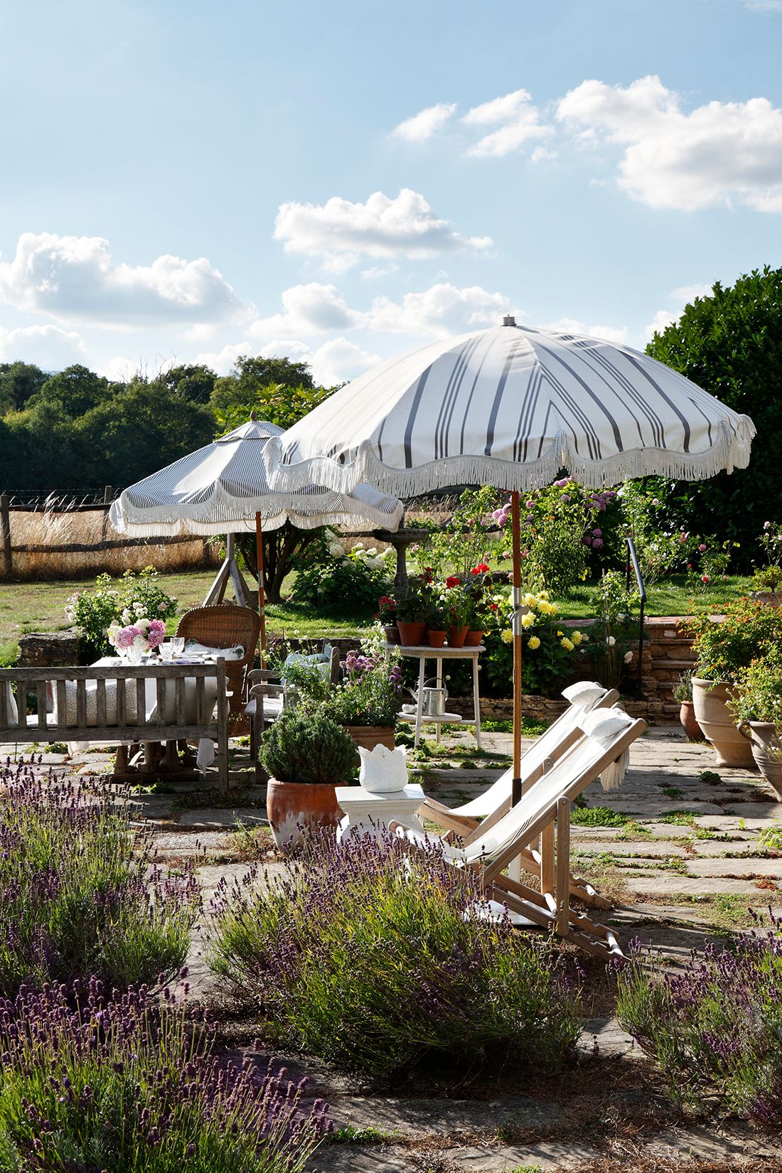 Image may contain Grass Plant Architecture Building House Housing Patio Chair Furniture Patio Umbrella and Garden