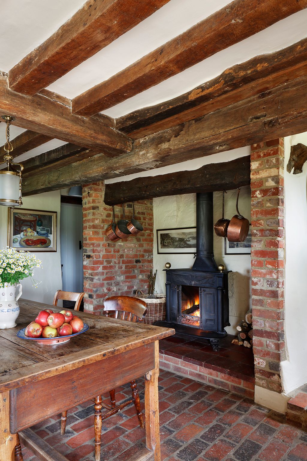 Image may contain Fireplace Indoors Lamp Desk Furniture Table Interior Design Chair Hearth Wood Art and Painting