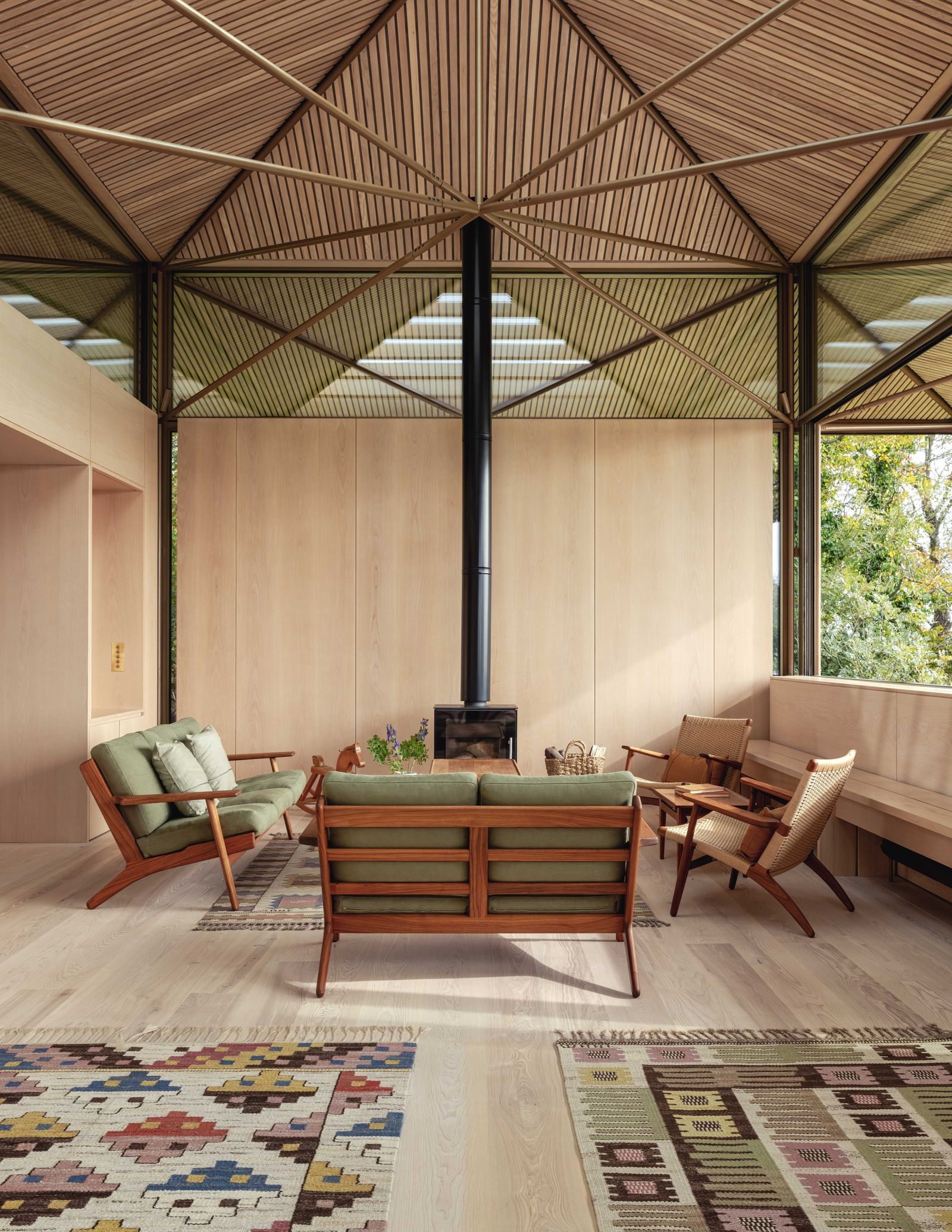 Image may contain Indoors Interior Design Home Decor Rug Coffee Table Furniture Table Chair Floor and Flooring