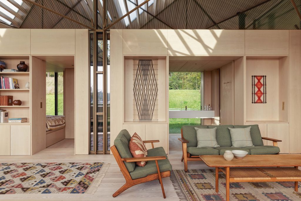 Image may contain Home Decor Indoors Interior Design Chair Furniture Rug Couch Architecture and Building