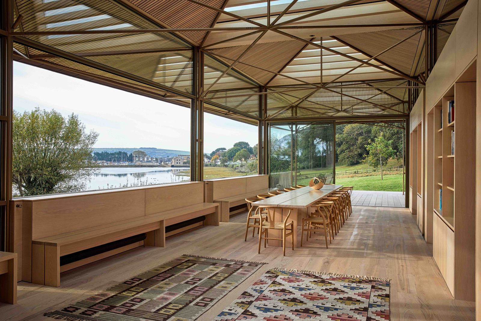 Image may contain Nature Outdoors Scenery Indoors Interior Design Wood Bench Furniture Home Decor Rug and Chair