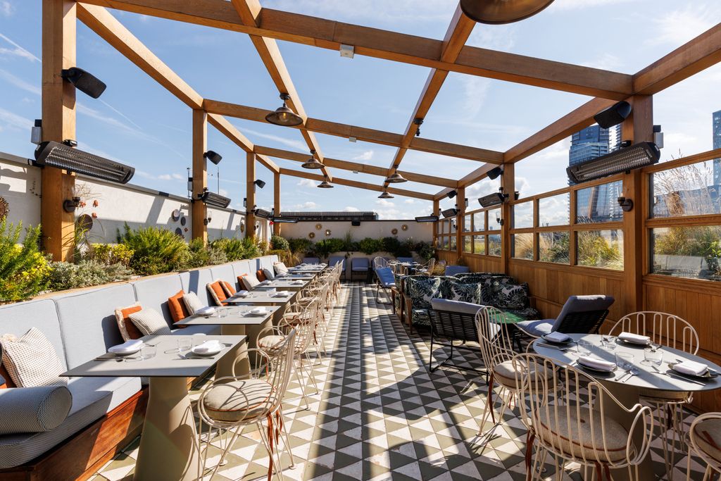 Image may contain Terrace Dining Table Furniture Table Indoors Restaurant Architecture Building Lounge and Chair