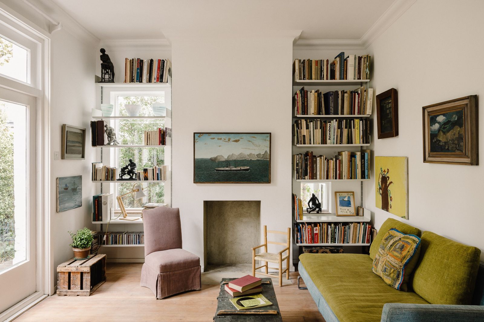 Image may contain Chair Furniture Plant Couch Book Publication Art Painting Bookcase Home Decor and Person