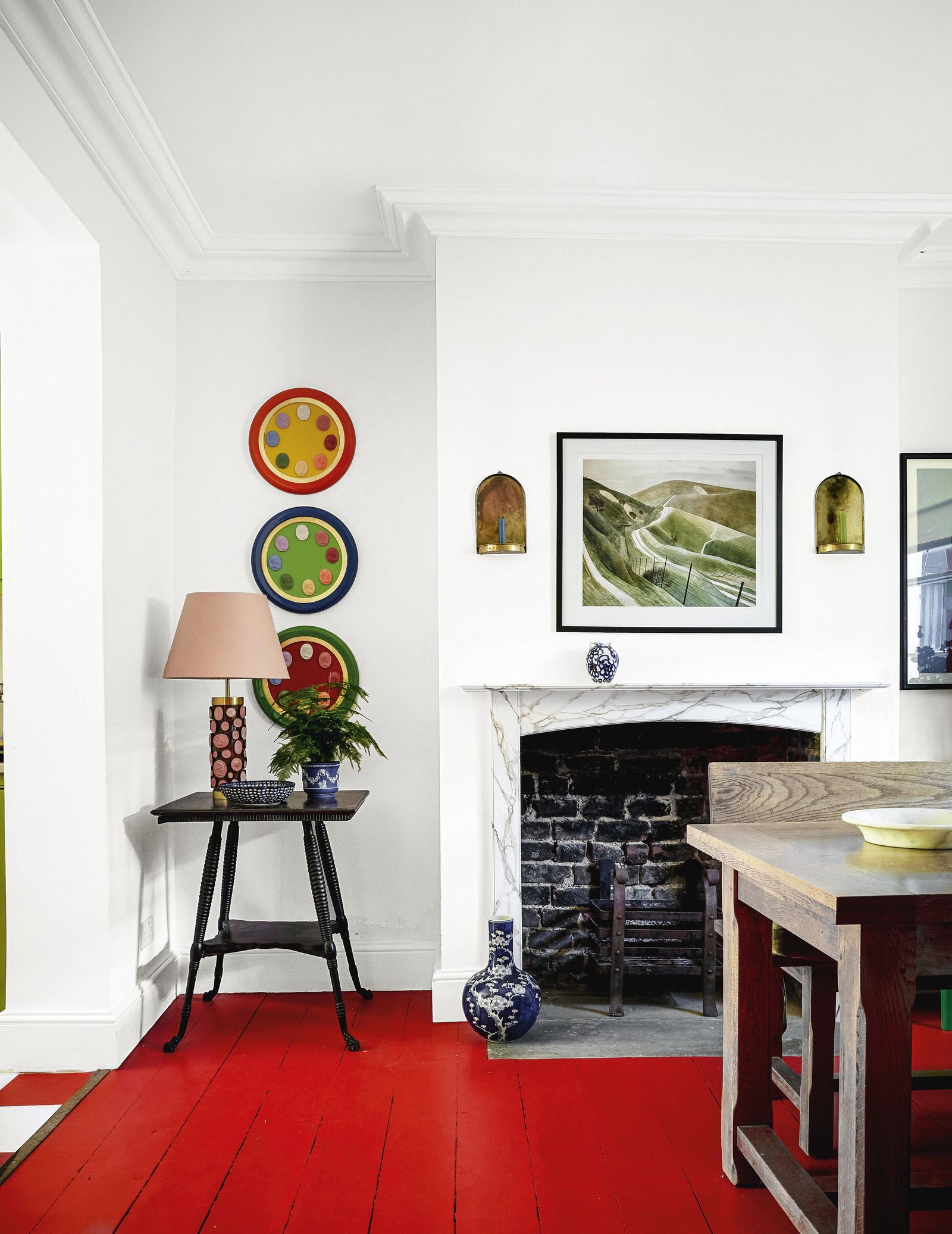 Image may contain Indoors Interior Design Lamp Plant Desk Furniture Table Home Decor Fireplace Art and Painting