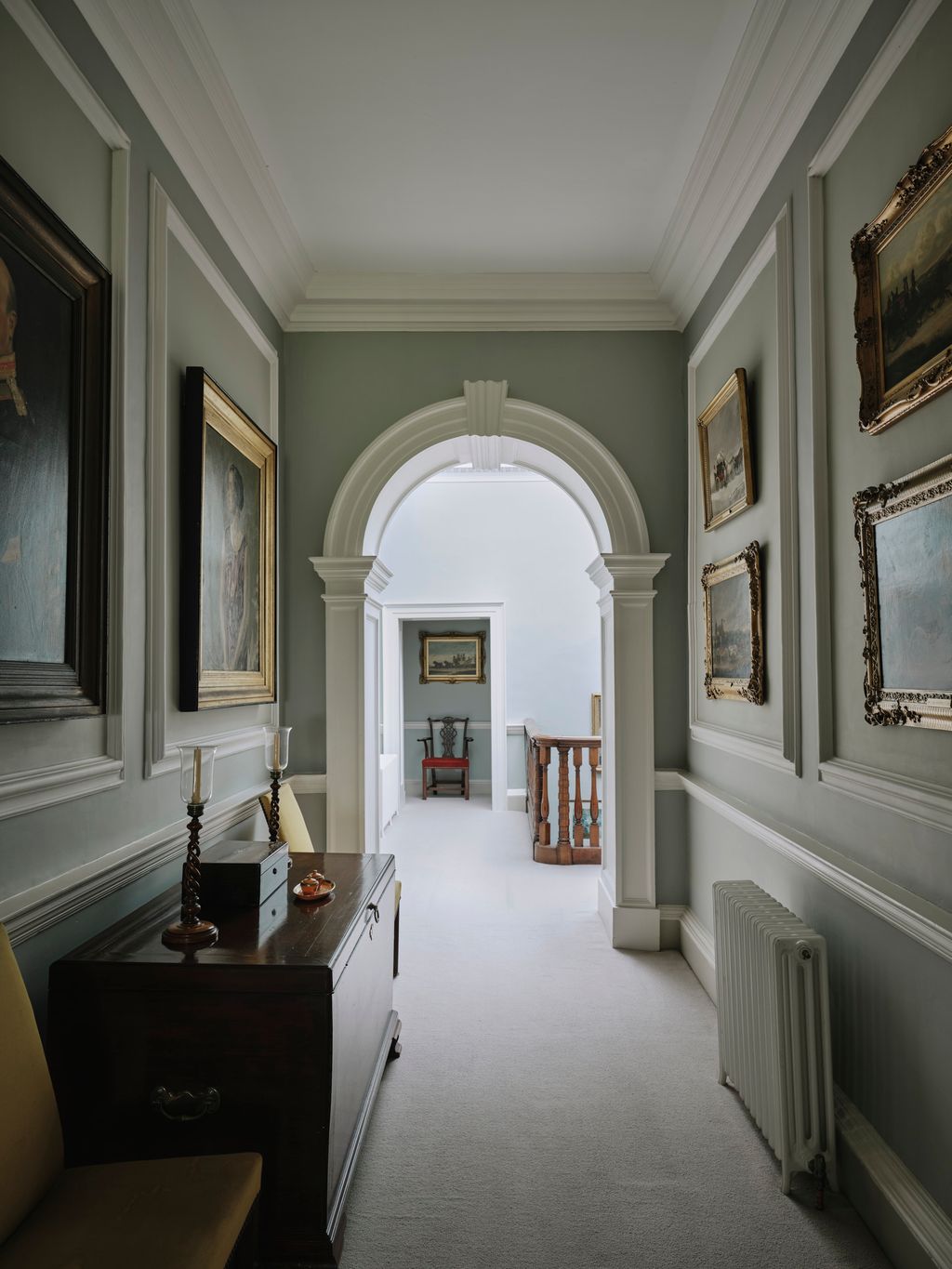 Image may contain Chair Furniture Art Painting Floor Indoors Arch Architecture Interior Design and Person