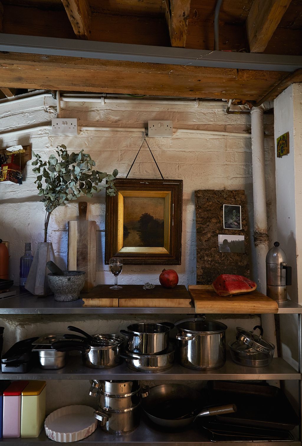 Image may contain Plant Art Painting Indoors Interior Design Person Wood Kitchen Shelf Cookware Pot and Box