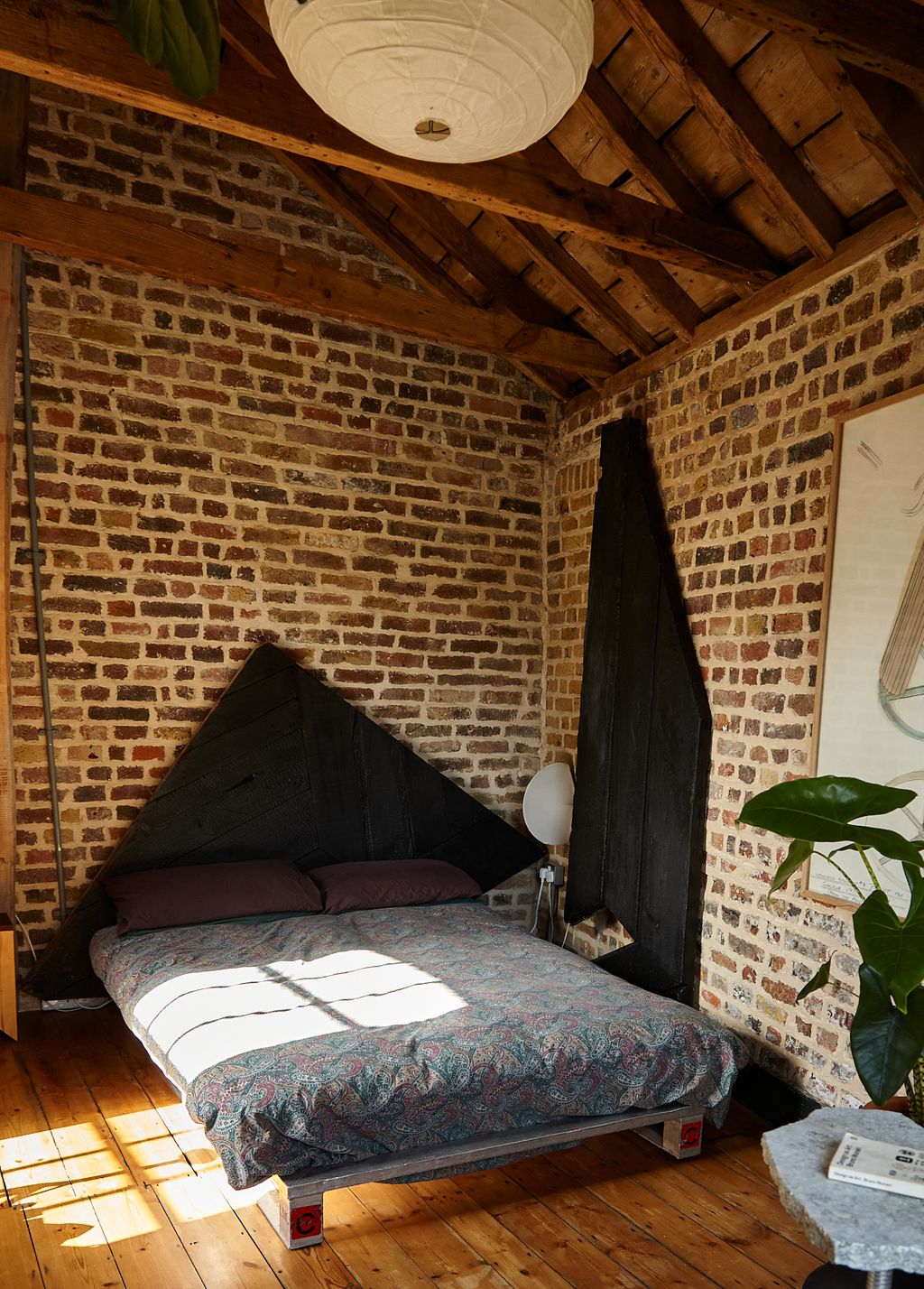 Image may contain Indoors Interior Design Lamp Book Publication Wood Hardwood Stained Wood Bed and Furniture