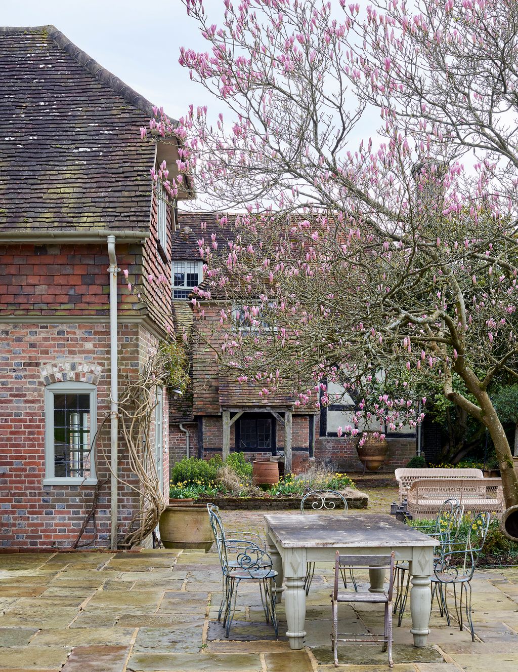 Image may contain Desk Furniture Table Path Walkway Chair Bench Architecture Building Housing Flagstone and House