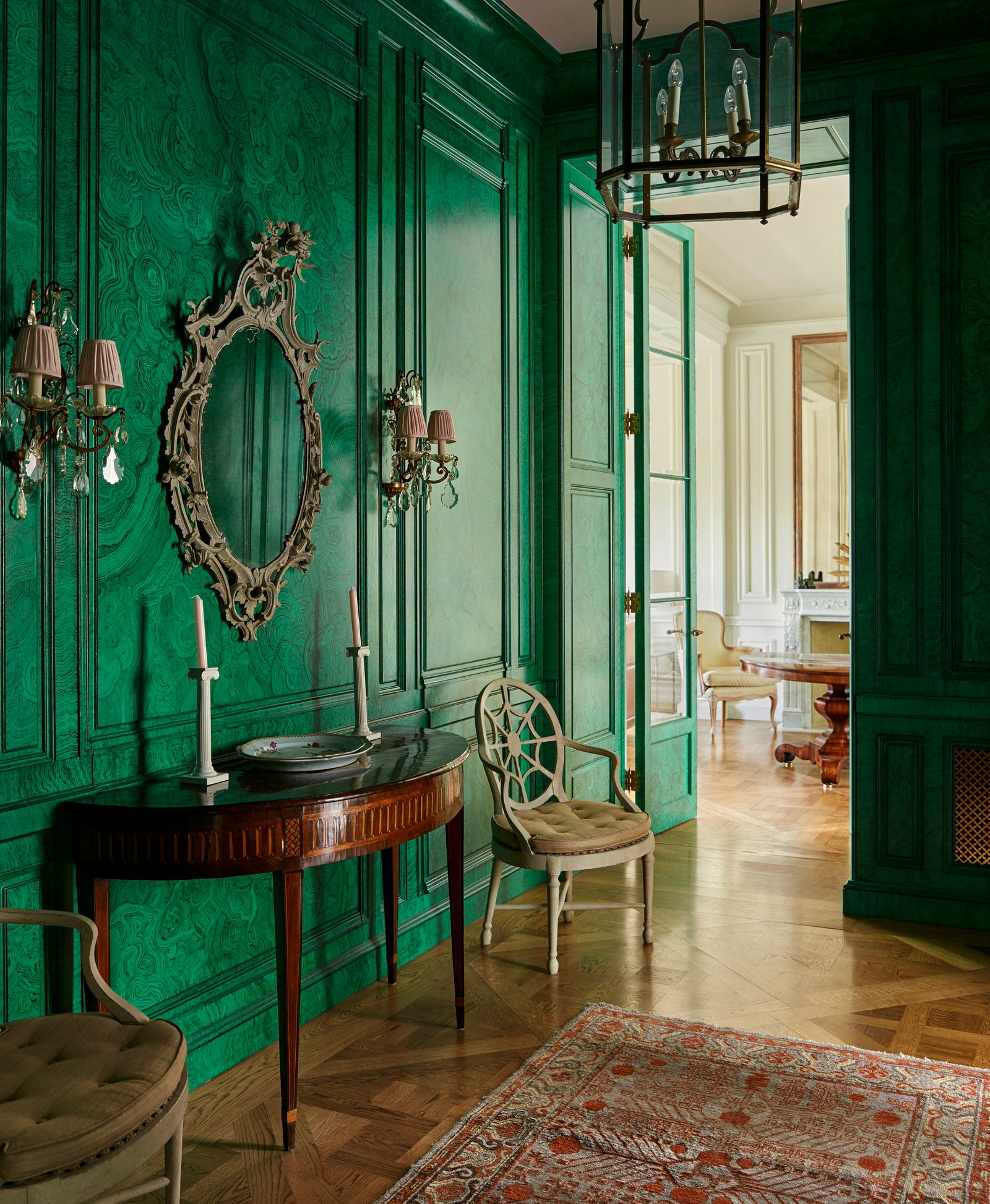 Image may contain Indoors Interior Design Chair Furniture Desk Table Home Decor Rug Floor Lamp and Architecture