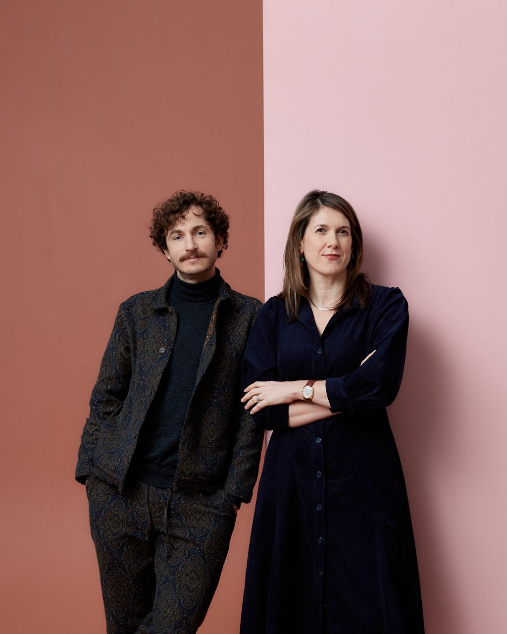 Image may contain Face Happy Head Person Smile Clothing Coat Adult Wristwatch Accessories Jewelry and Necklace