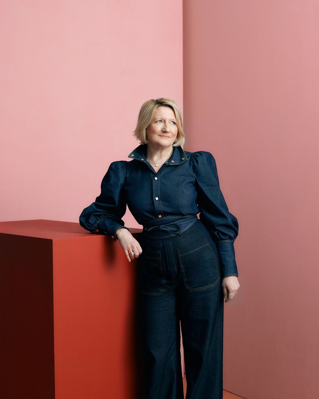 Image may contain Clothing Pants Jeans Adult Person Accessories Jewelry Necklace Coat and Standing