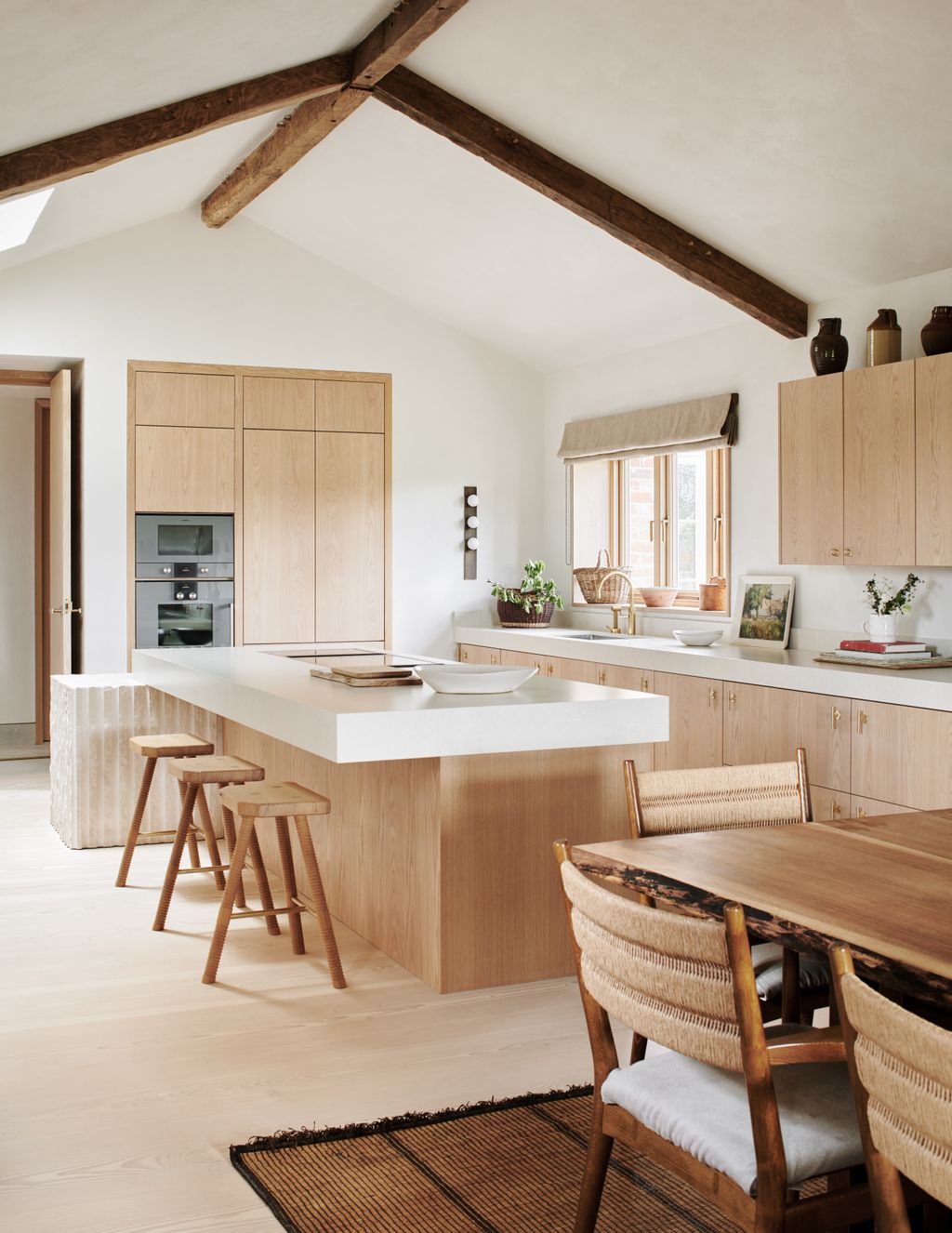 Image may contain Indoors Interior Design Kitchen Wood Chair Furniture Plant Dining Table Table Art and Painting