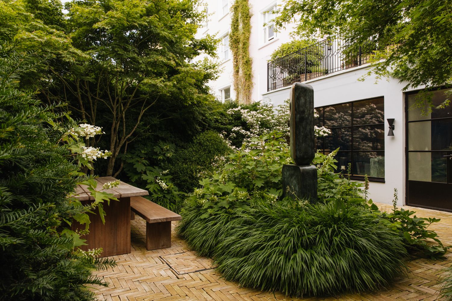 Image may contain Bench Furniture Plant Vegetation Backyard Nature Outdoors Yard Tree Garden Lamp Grass and Land