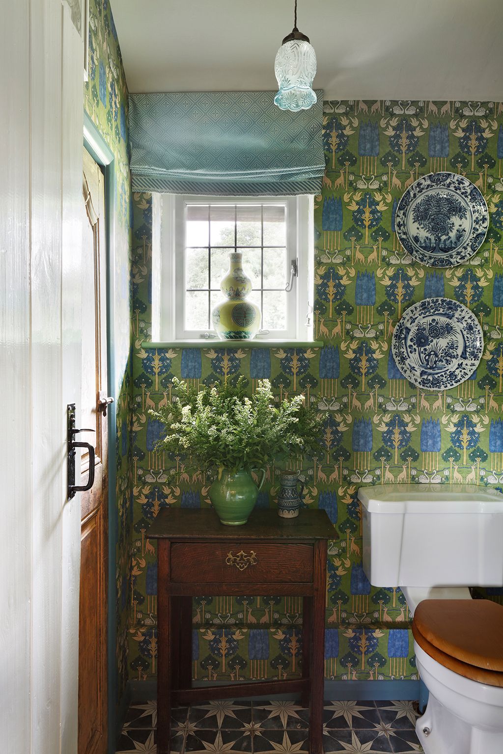 Image may contain Indoors Interior Design Lamp Sink Plate Bathroom Room Toilet Sink Faucet and Home Decor