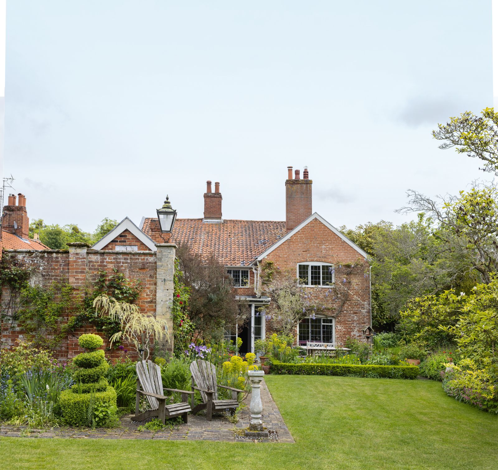 Image may contain Architecture Building Housing House Manor Chair Furniture and Person