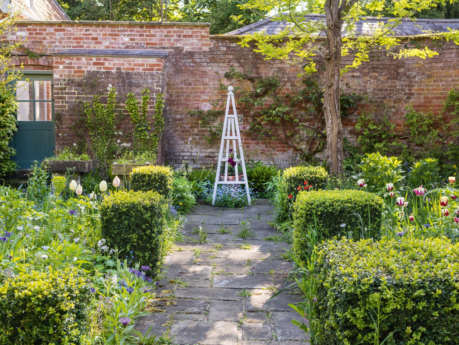 Image may contain Garden Nature Outdoors Backyard Yard Fence Hedge Plant Indoors Interior Design and Architecture