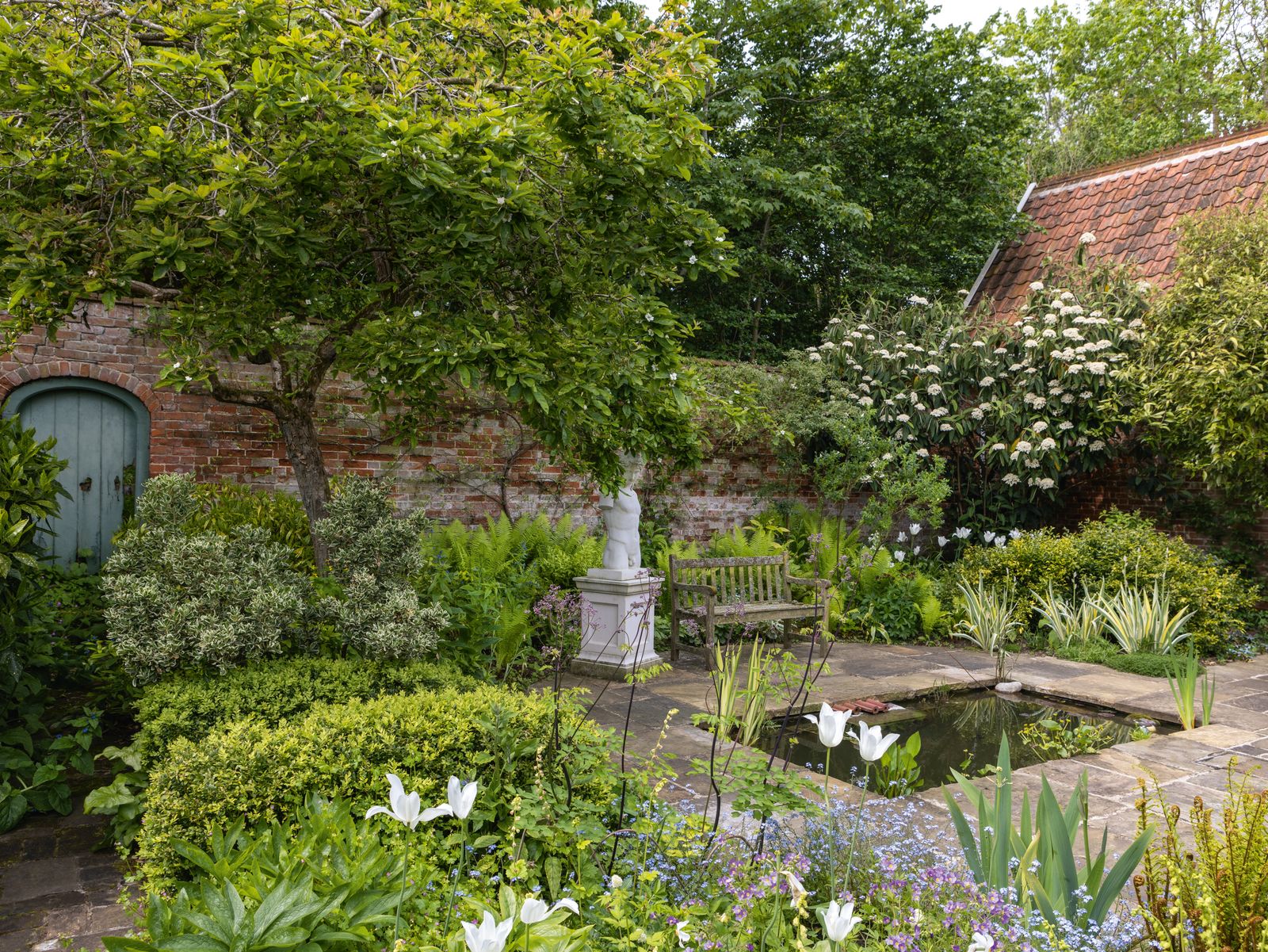 Image may contain Garden Nature Outdoors Backyard Yard Pond Water Bench Furniture Plant Vegetation and Herbal