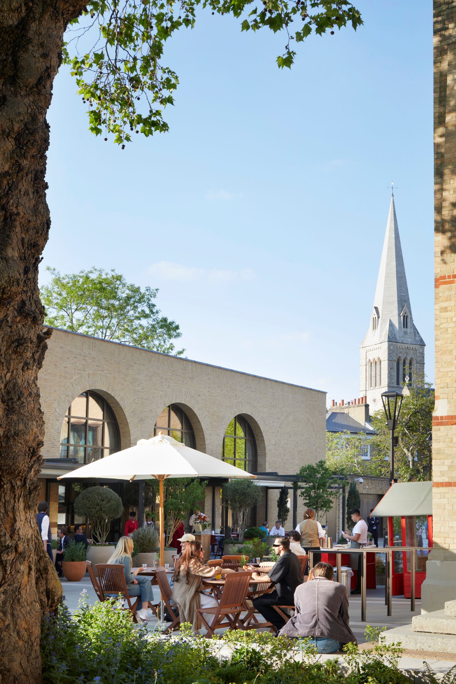 Image may contain Architecture Building Spire Tower Indoors Restaurant Plant Adult Person Urban City and Clothing