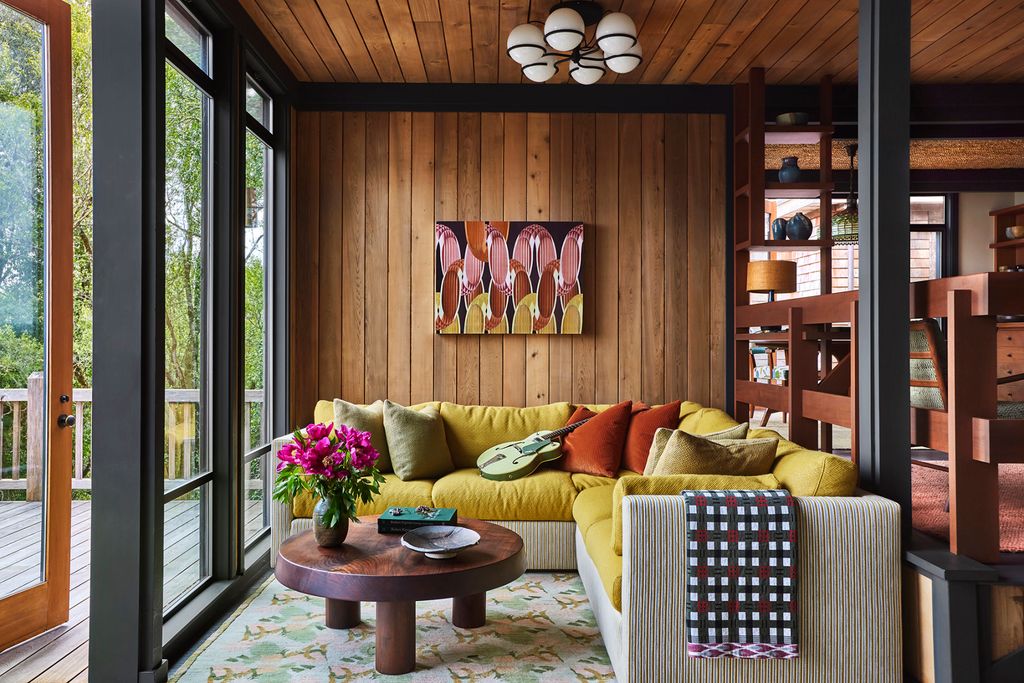 Image may contain Indoors Interior Design Lamp Home Decor Wood Panels Rug Guitar Musical Instrument and Architecture