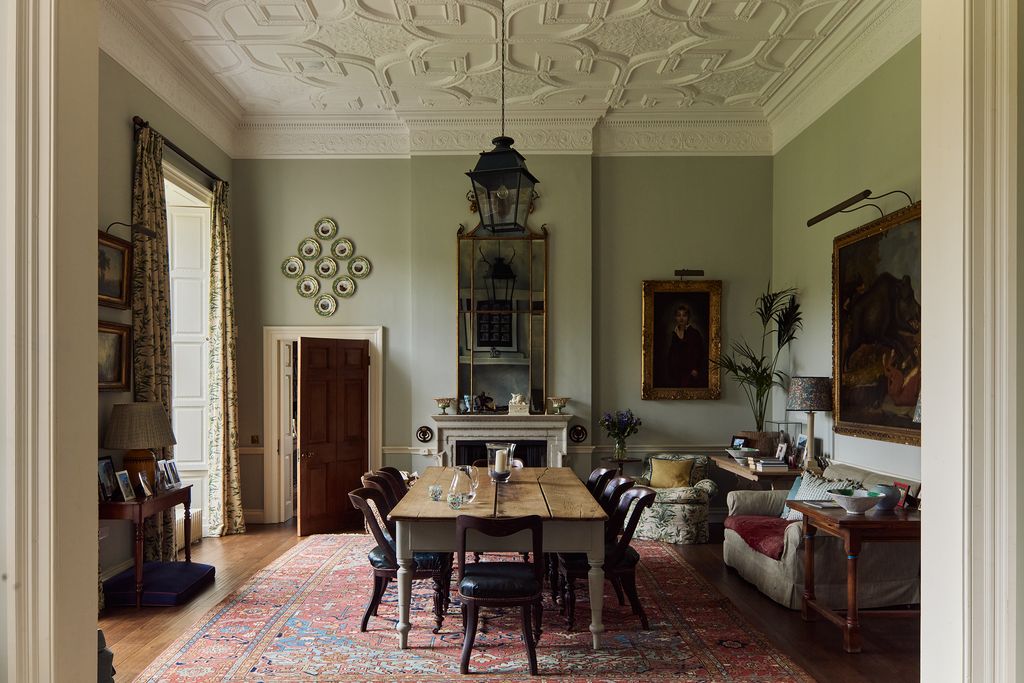 Image may contain Architecture Building Dining Room Dining Table Furniture Indoors Room Table Home Decor and Lamp