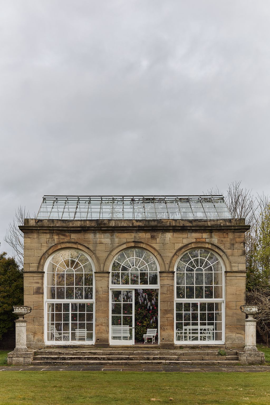 Image may contain Arch Architecture Gothic Arch French Window Window Bench Furniture and Chair