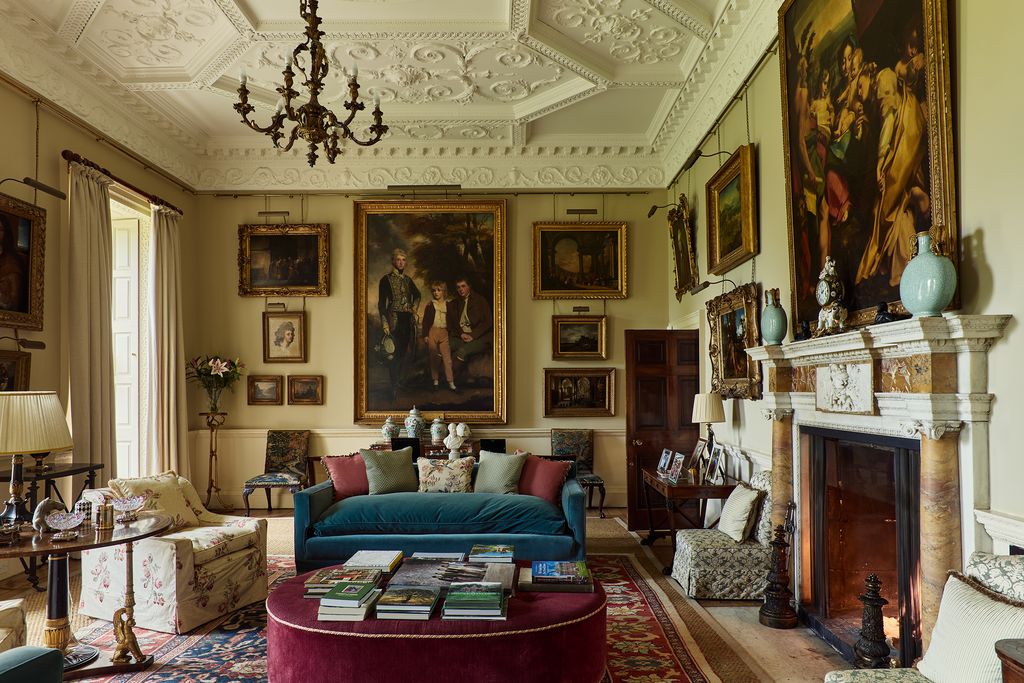 Image may contain Home Decor Art Painting Chair Furniture Lamp Architecture Building Indoors Living Room and Room