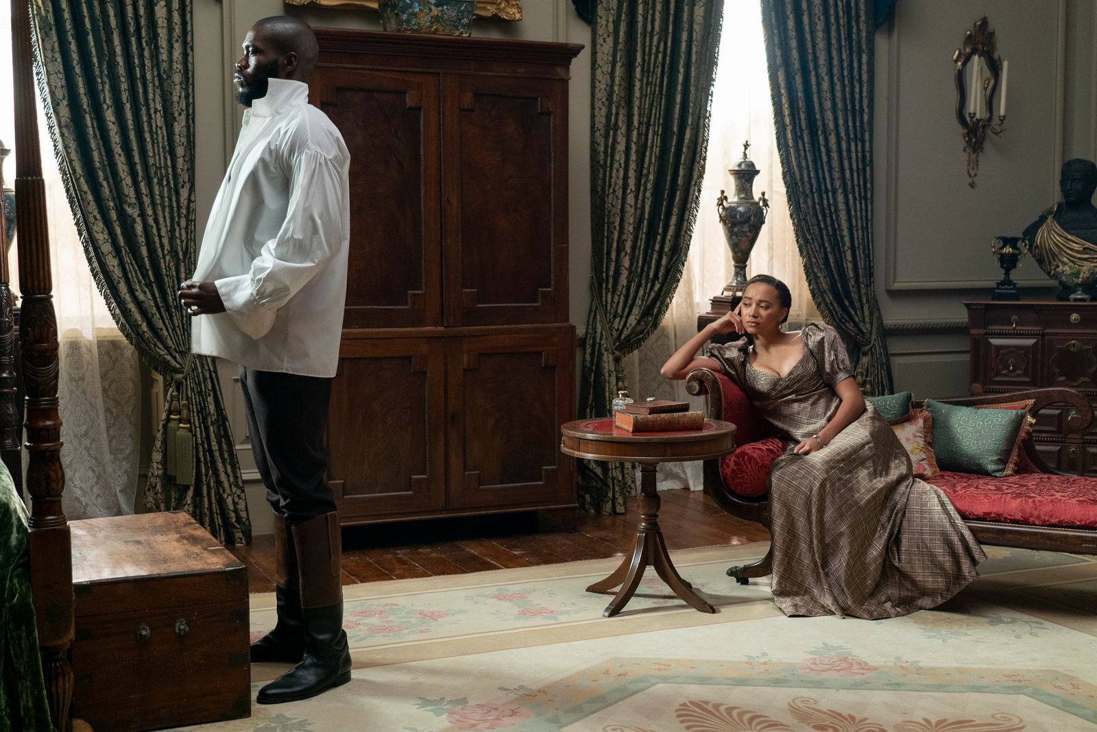 Image may contain Desk Furniture Table Adult Person Clothing Footwear Shoe and Couch