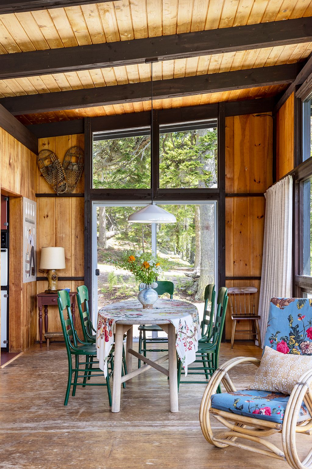 Image may contain Indoors Interior Design Lamp Chair Furniture Desk Table Wood Dining Table Window and Hardwood