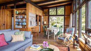 Image may contain Indoors Interior Design Home Decor Chair Furniture Wood Couch Lamp Rug Table and Dining Table