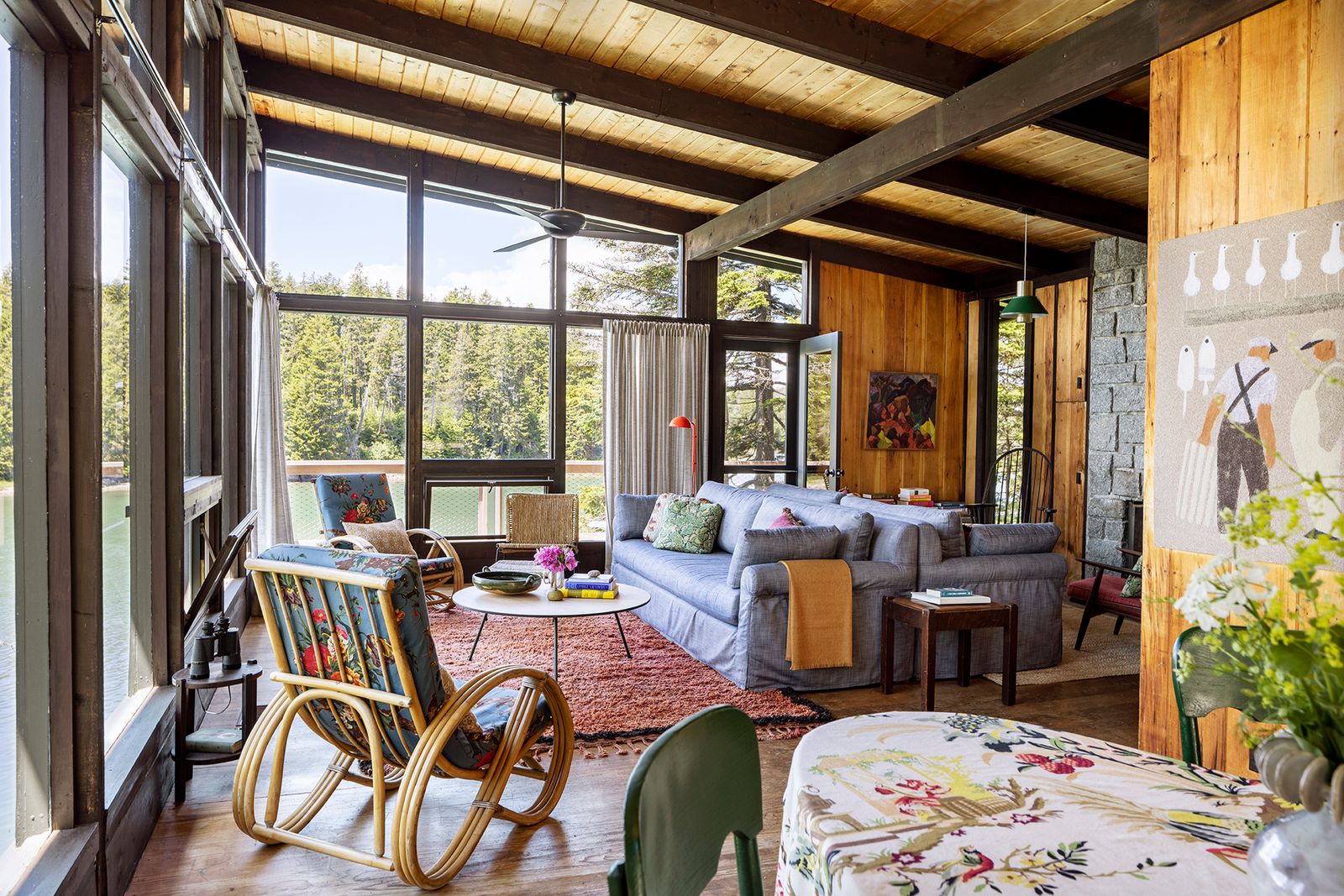 Image may contain Indoors Interior Design Home Decor Chair Furniture Lamp Couch Desk Table Rug Wood and Person