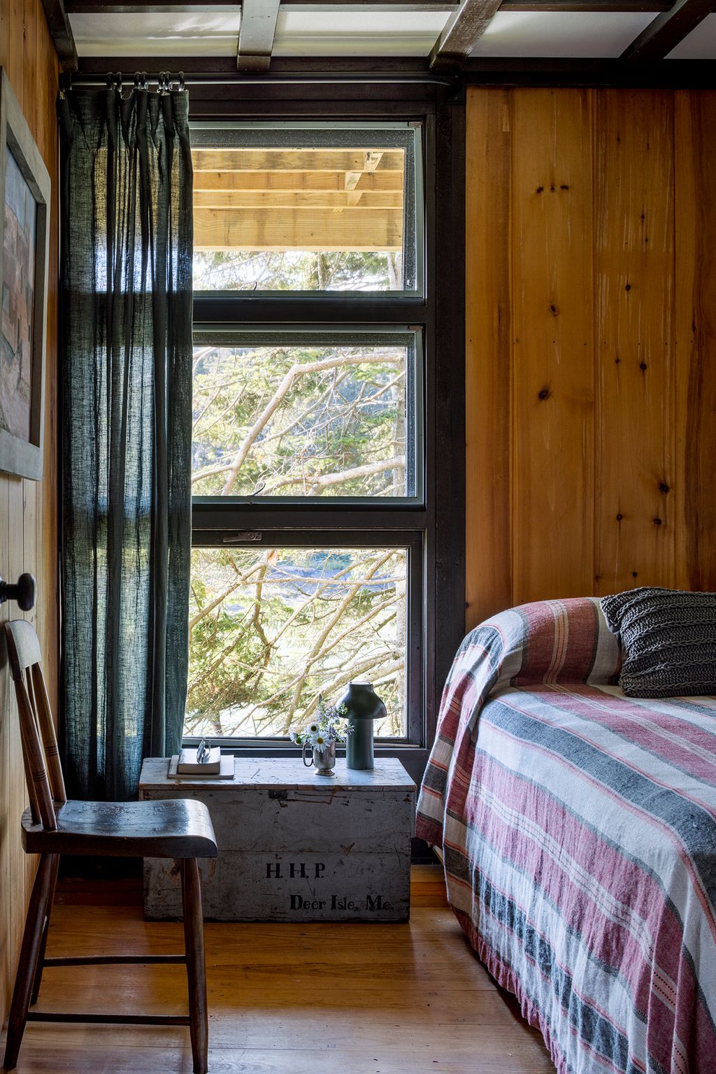 Image may contain Indoors Interior Design Wood Chair Furniture Hardwood Bed Lamp Window and Stained Wood