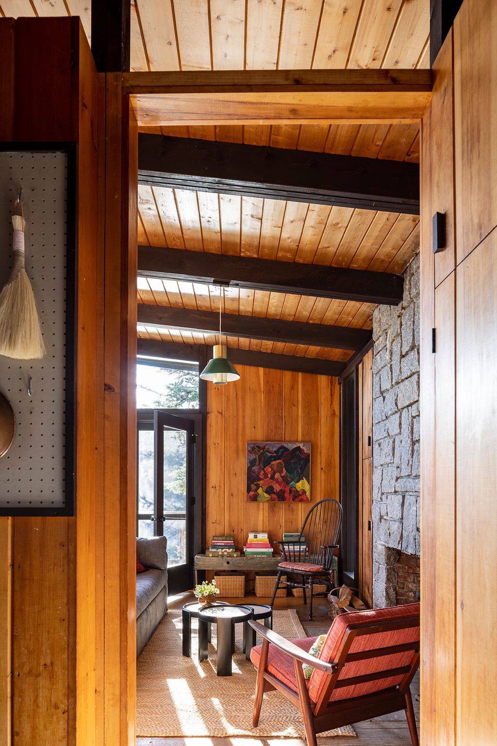 Image may contain Indoors Interior Design Wood Chair Furniture Lamp Hardwood Stained Wood Wood Panels and Couch