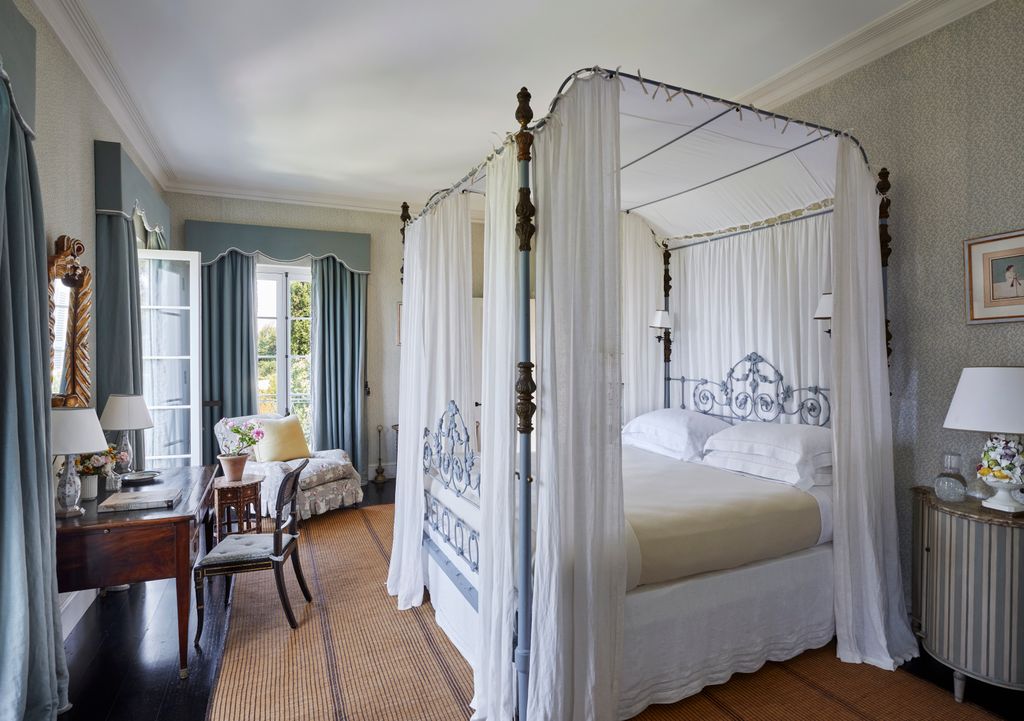 Image may contain Furniture Indoors Bed Bedroom Room Lamp Chair Art Painting Desk Table Plant Person and Couch