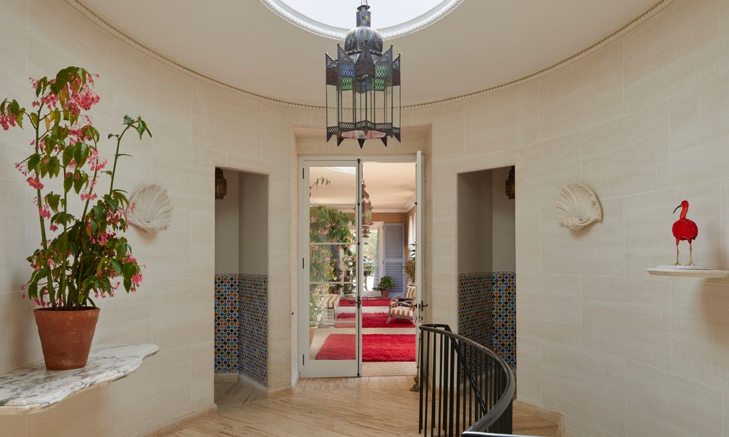 Image may contain Plant Architecture Building Foyer Indoors Chair Furniture Animal Bird Home Decor and Rug