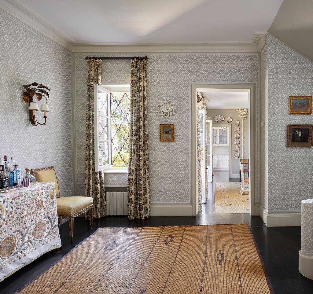 Image may contain Chair Furniture Floor Home Decor Rug Indoors Interior Design Art Painting Desk and Table