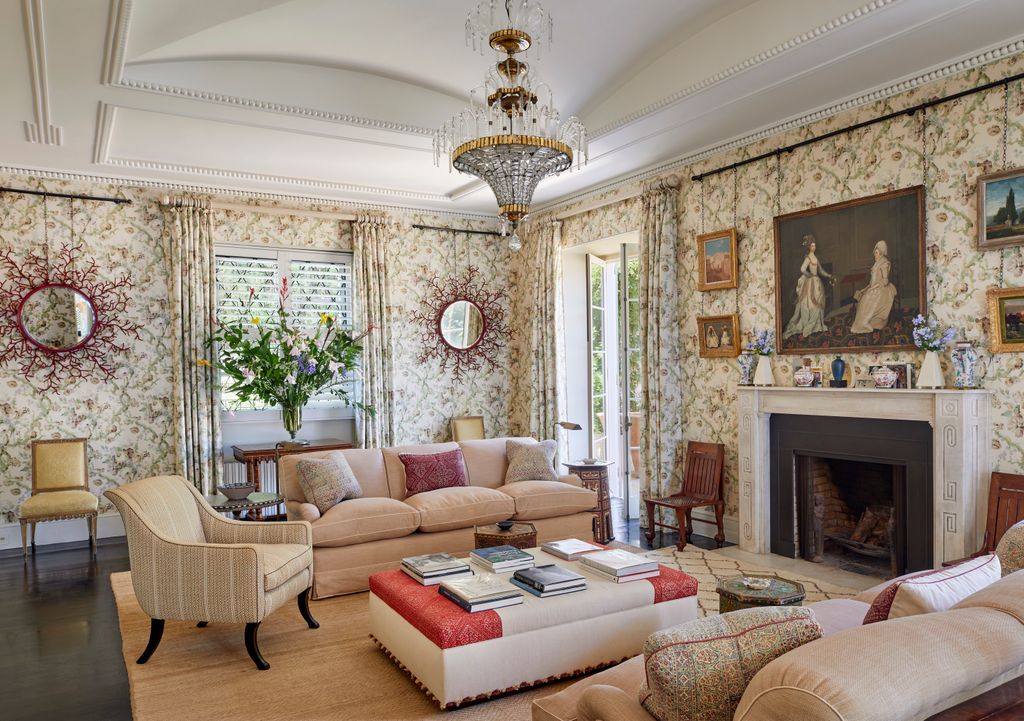 Image may contain Home Decor Chair Furniture Art Painting Book Publication Couch Person Chandelier Lamp and Rug