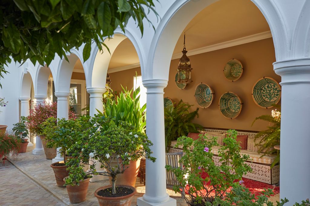 Image may contain Architecture Building House Housing Villa Plant Potted Plant Hacienda Lamp Plate and Jar