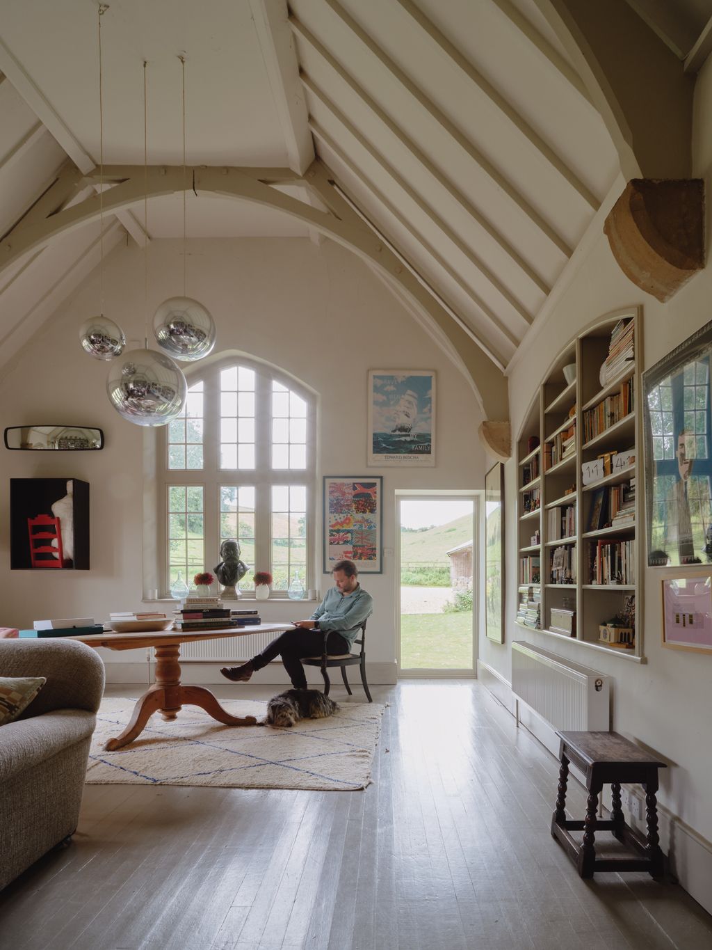 Image may contain Chair Furniture Adult Person Architecture Building Indoors Living Room Room and Vault Ceiling