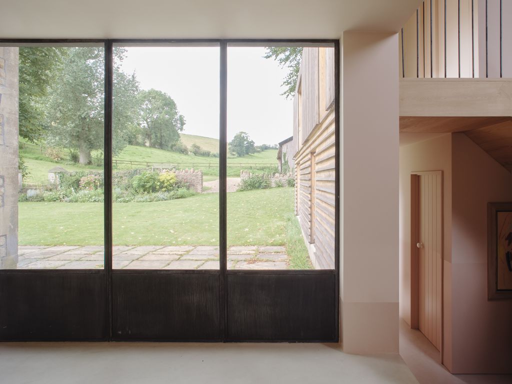 Image may contain Indoors Interior Design Door Sliding Door Art Painting Window Architecture Building and Housing
