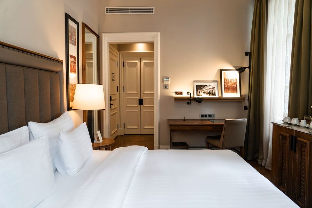 Image may contain Corner Lamp Chair Furniture Cushion Home Decor Indoors Interior Design Table Lamp Bed and Art