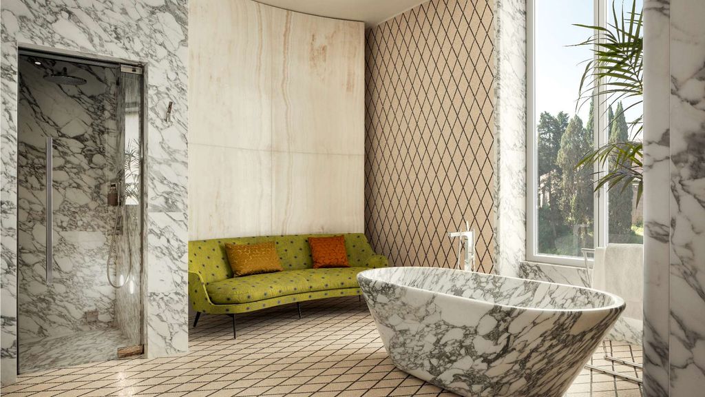 Image may contain Indoors Interior Design Bathing Bathtub Person Tub Couch Furniture Home Decor and Plant